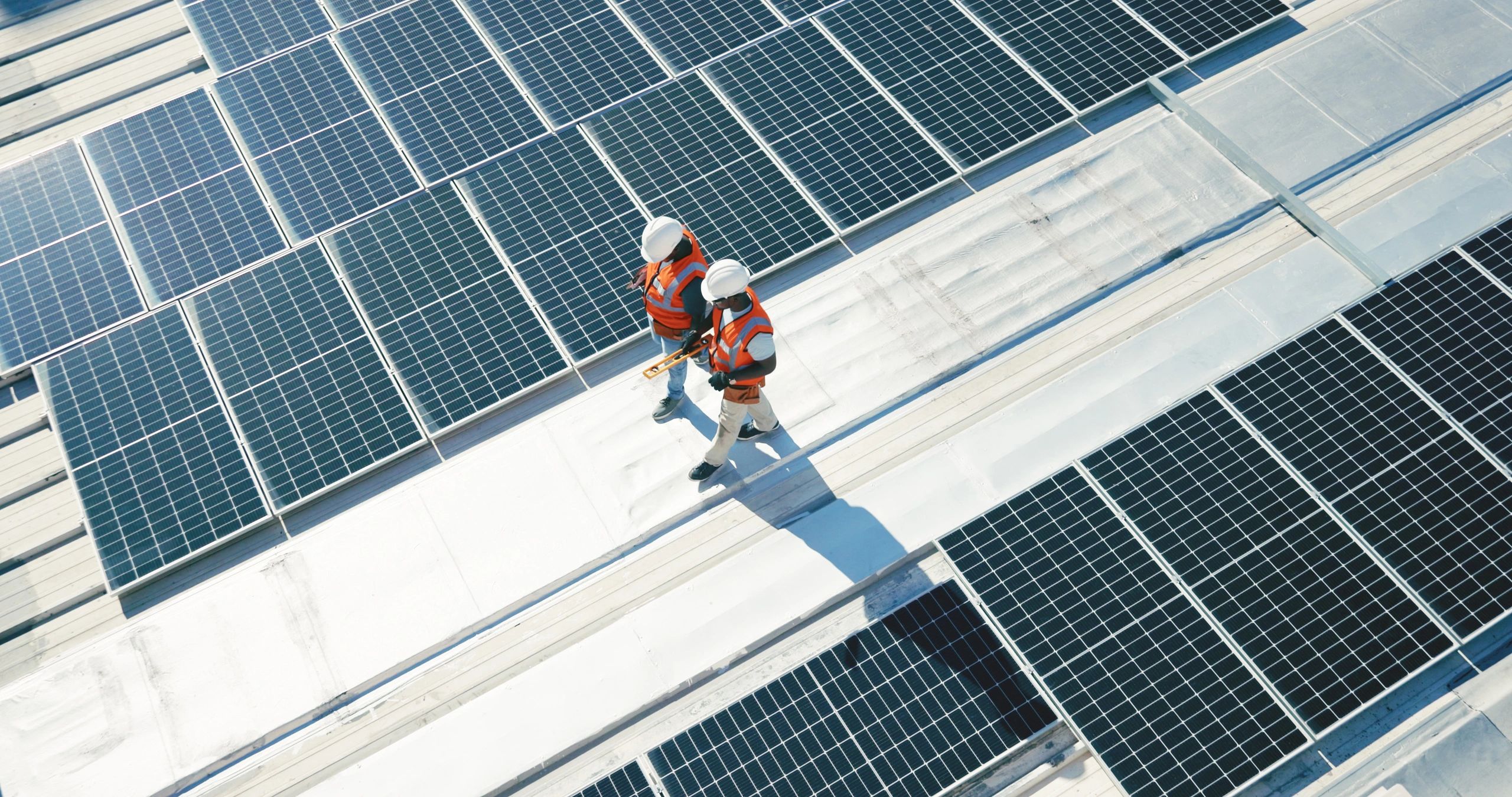 solar installation team reviewing solar panel project blueprint